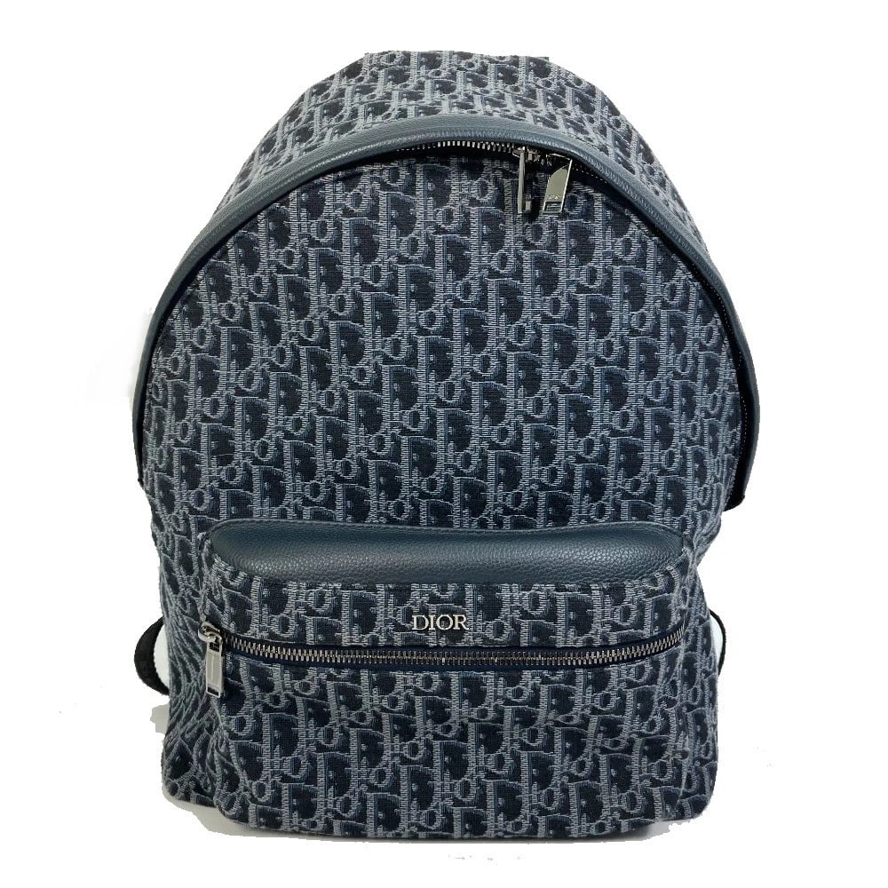 DIOR TROTTER OBLIQUE BACKPACK CANVAS/LEATHER NAVY: Dior Trotter Oblique Backpack Canvas/Leather Navy Brand: Dior Type/Style: Backpack Material: Canvas/Leather Color: Navy Size: W11.8xH16.1xD5.9inch / W30cmxH41cmxD15cm Accessories: None Accessories