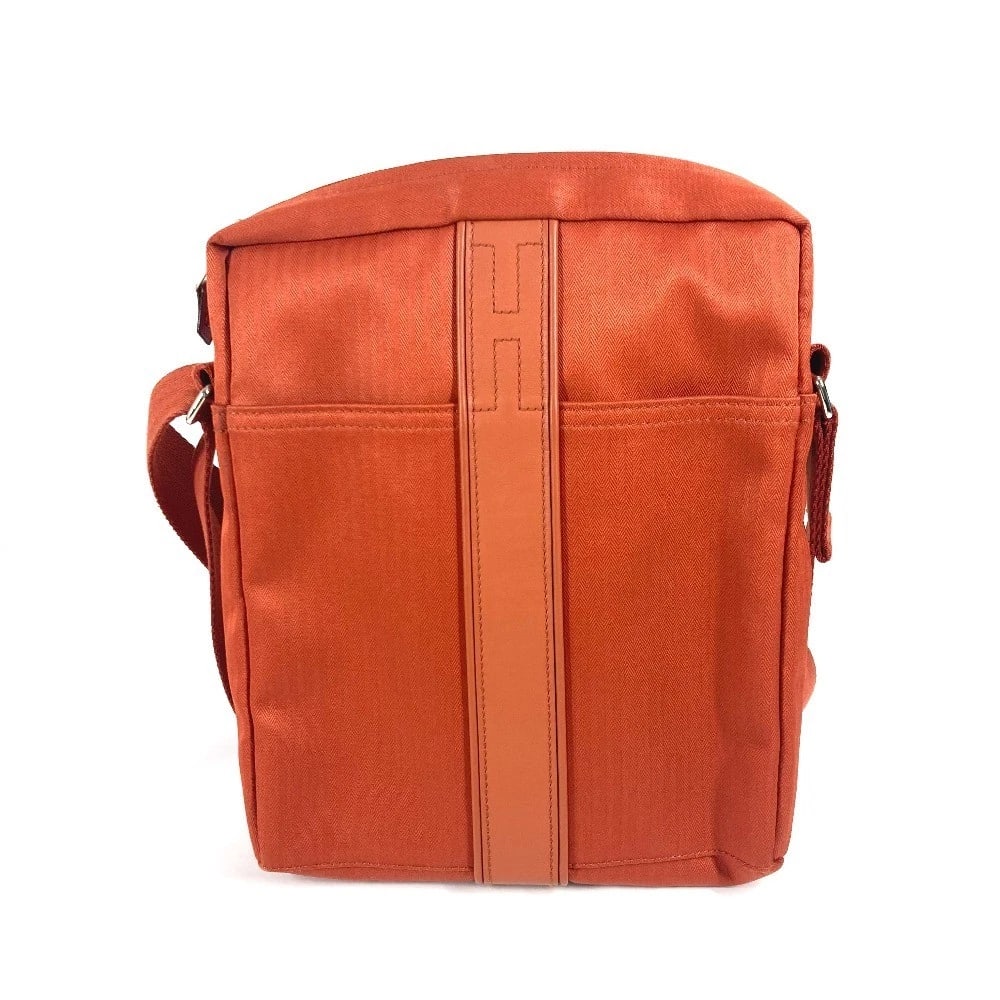 HERMES POCHETTE ACAPULCO BANDOULIERE PM CROSSBODY SHOULDER BAG: HERMES Pochette Acapulco Bandouliere PM Crossbody Shoulder Bag Brand: HERMES Type/Style: Shoulder Bag Material: Nylon canvas Color: Orange Size: W0.8xH10.4xD2.2inch / W2cmxH26.5cmxD5.5cm Accessories: