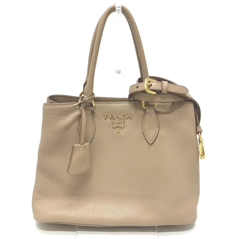 PRADA LOGO 2WAY HAND BAG: PRADA logo 2WAY Hand Bag Brand: PRADA Type/Style: Hand Bag Material: Leather Color: Beige Size: W13.4xH9.1xD6.3inch / W34cmxH23cmxD16cm Handle: 15.0inch / 38cm Accessories: None Accessorie