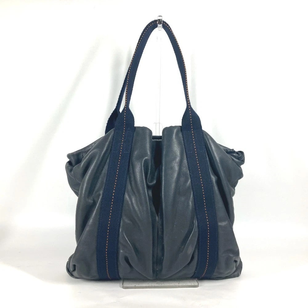 HERMES CARAVAN VERTICAL MM SHOULDER BAG: HERMES Caravan Vertical MM Shoulder Bag Brand: HERMES Type/Style: Tote Bag Material: Leather Color: Navy / Orange Size: W15.0xH12.0xD2.2inch / W38cmxH30.5cmxD5.5cm Accessories: None Access