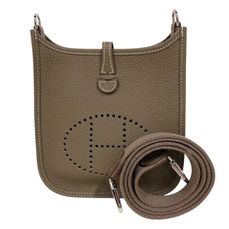 HERMES EVELYNE ETOUPE/SHW SHOULDER BAG: HERMES Evelyne Etoupe/SHW Shoulder Bag Brand: HERMES Type/Style: Shoulder Bag Material: Taurillon Clemence Color: Etoupe // SV Hardware Size: W: 17.5cm / H: 19cm / D: 5cm Accessories: None