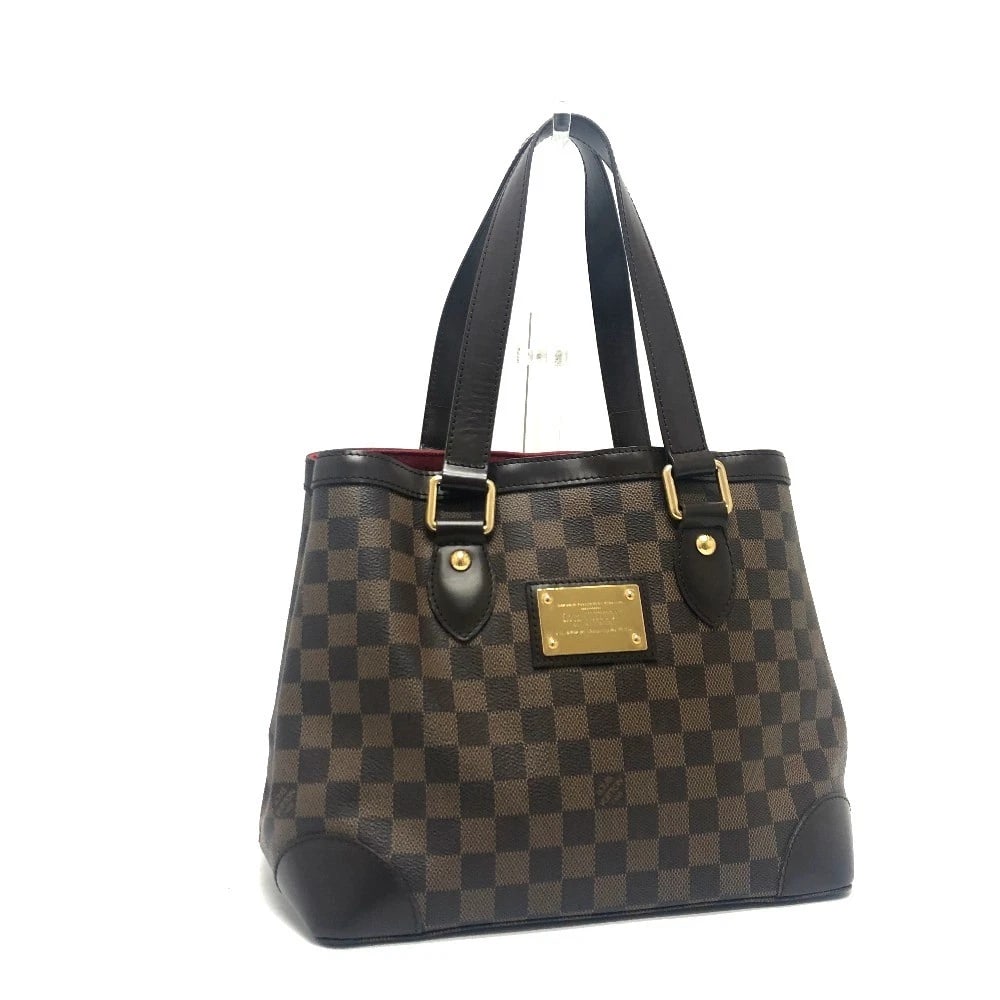 LOUIS VUITTON DAMIER HAMPSTEAD PM HAND BAG: LOUIS VUITTON Damier Hampstead PM Hand Bag Brand: LOUIS VUITTON Type/Style: Tote Bag Material: Damier Canvas Color: Ebene / Brown / GoldHardware Size: W11.0xH9.4xD7.1inch / W28cmxH24cmxD18cm Handle: 1