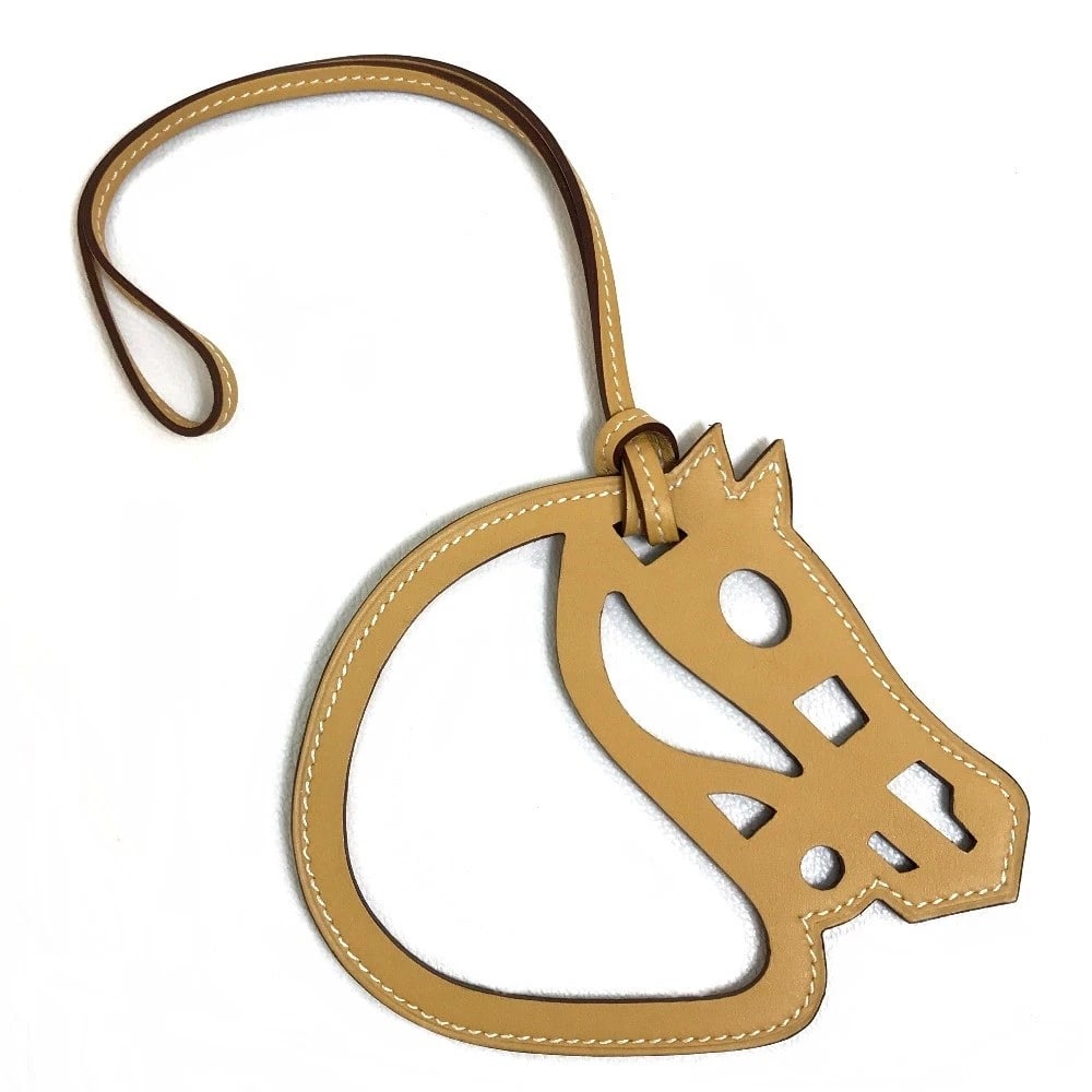 HERMES PETIT ASH PADDOCK CHEVAL STRAP: HERMES Petit Ash Paddock Cheval strap Brand: HERMES Type/Style: charm Material: Vo Swift Color: Beige Size: Total Length: 11.4inch / 29cm Motif: 4.5inchx 3.9inch Accessories: None Accessories Notice: