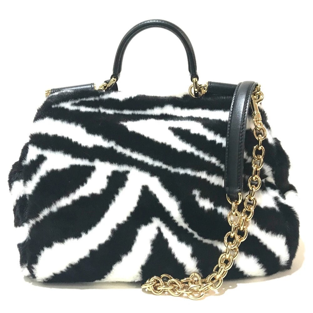 UNDOLCE&GABBANA ZEBRA PATTERN HAND BAG: UNDOLCE&GABBANA Zebra pattern Hand Bag Brand: DOLCE&GABBANA Type/Style: Shoulder Bag Material: Faux fur / Leather Color: Black/ White Size: W9.8xH8.3xD5.1inch / W25cmxH21cmxD13cm Accessories: None