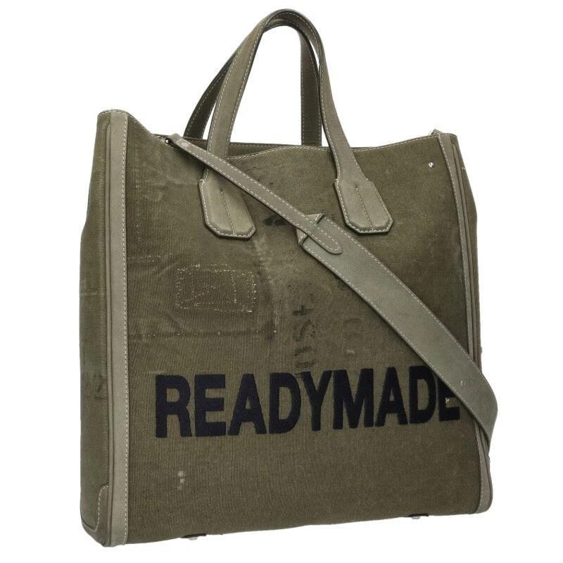 READYMADE BAG: LOGO EMBROIDERY FABRIC: READYMADE Bag: Logo Embroidery Fabric Brand: READYMADE Type/Style: Tote Material: Exterior Material Canvas Color: Exterior Color Khaki Size: (approx. W14.6 ? H14.4 ? D4.1 inch) Accessories: None