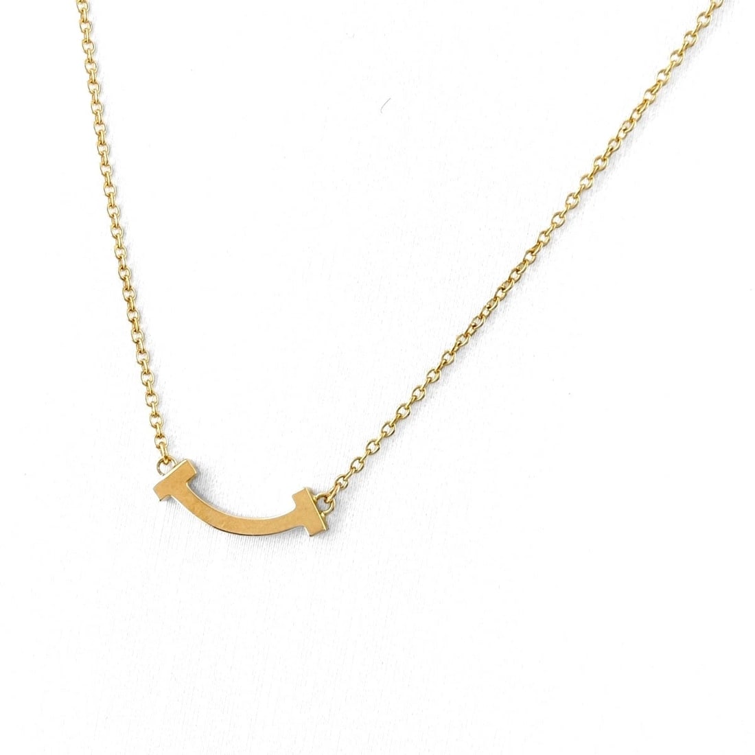 TIFFANY&CO. T SMILE MINI NECKLACE PG PENDANT NECKLACE: Tiffany&Co. T Smile Mini Necklace Pg Pendant Necklace Brand: TIFFANY&Co. Type/Style: Necklace Material: 750PG, Main Stone None Color: PG Size: 4.5x13.7mm(0.2") Accessories: None Accessorie