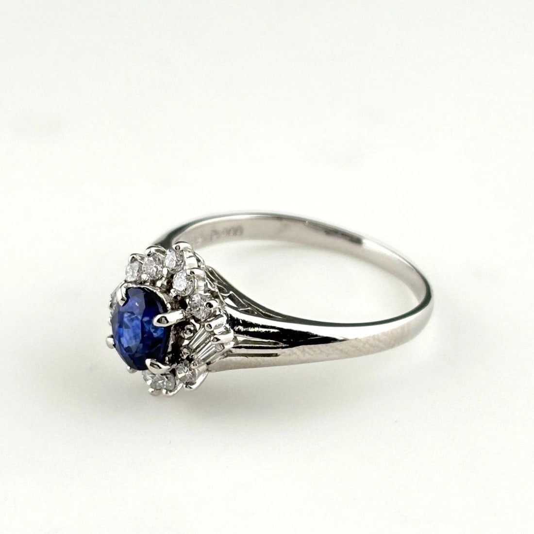SAPPHIRE DESIGN RING PLATINUM MELEE DIAMOND RING: Sapphire Design Ring Platinum Melee Diamond Ring Brand: Unbranded Type/Style: Ring Material: Pt900, Main Stone Sapphire /Secondary Stone:Natural Color: None Size: US6.5 to 7 Accessories: None
