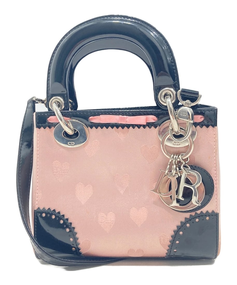 CHRISTIAN DIOR DIORAMOUR HEART CANVAS LEATHER 2WAY SHOULDER HANDBAG: Christian Dior Dioramour Heart Canvas Leather 2WAY Shoulder Handbag Brand: Dior Type/Style: Top Handle Bag Material: Satin ? Enamel / Patent Leather Color: Pink Size: Height: Approx. 5.9 inches Width: