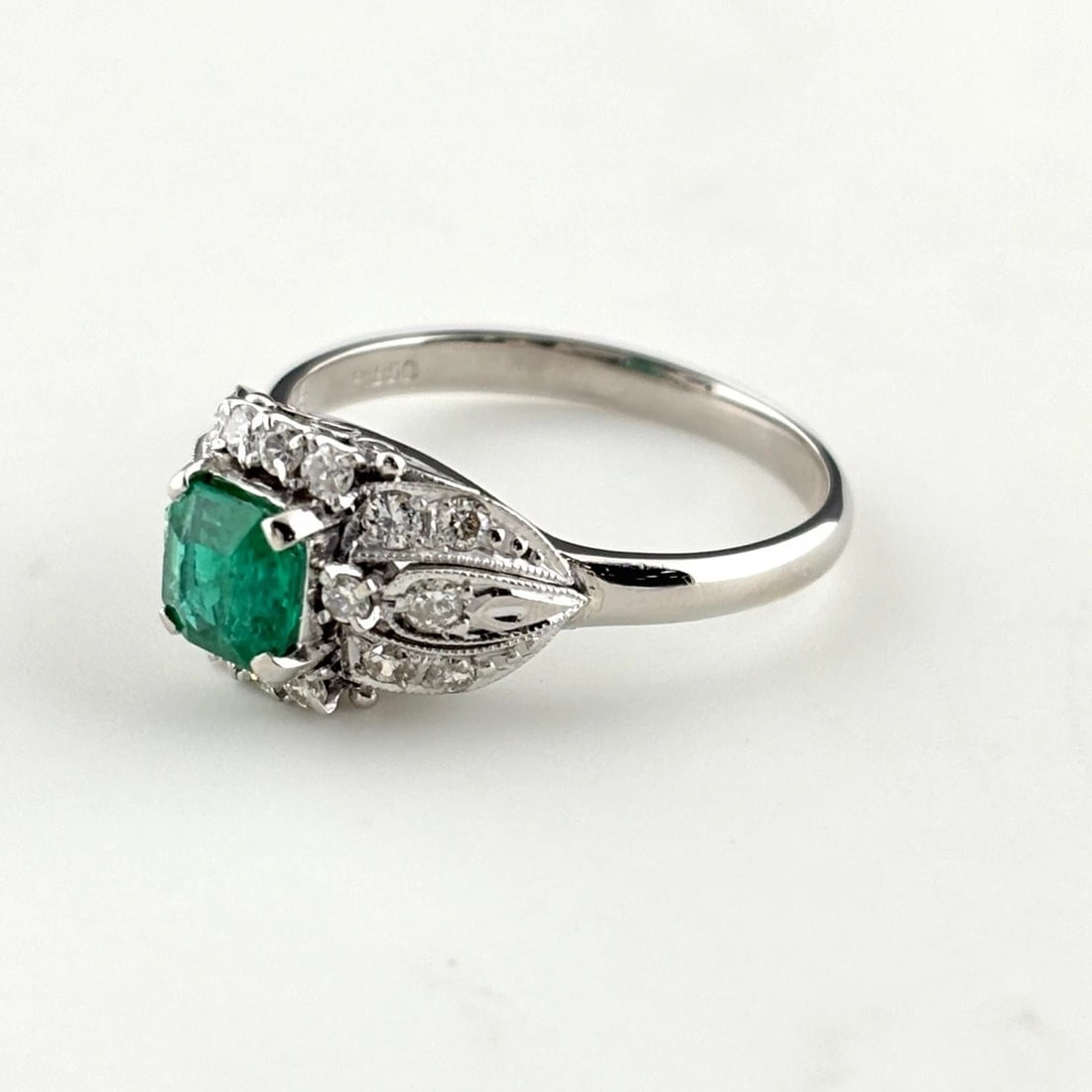 EMERALD DESIGN RING PLATINUM MELEE DIAMOND RING: Emerald Design Ring Platinum Melee Diamond Ring Brand: Unbranded Type/Style: Ring Material: Pt850, Main Stone Emerald /Secondary Stone:Natural Color: None Size: US6.5 to 7 Accessories: None