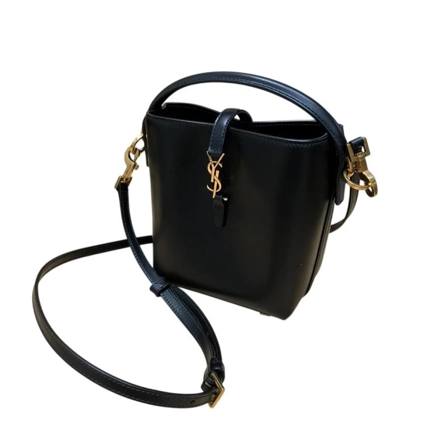 SAINT LAURENT PARIS BAG: YSL LOGO BUCKET BLACK: SAINT LAURENT PARIS Bag: YSL Logo Bucket Black Brand: Saint Laurent Paris Type/Style: Shoulder Bag Material: Exterior Material Leather Color: Exterior Color Black Size: (approx. W5.5 ? H6.7 ? D3.1