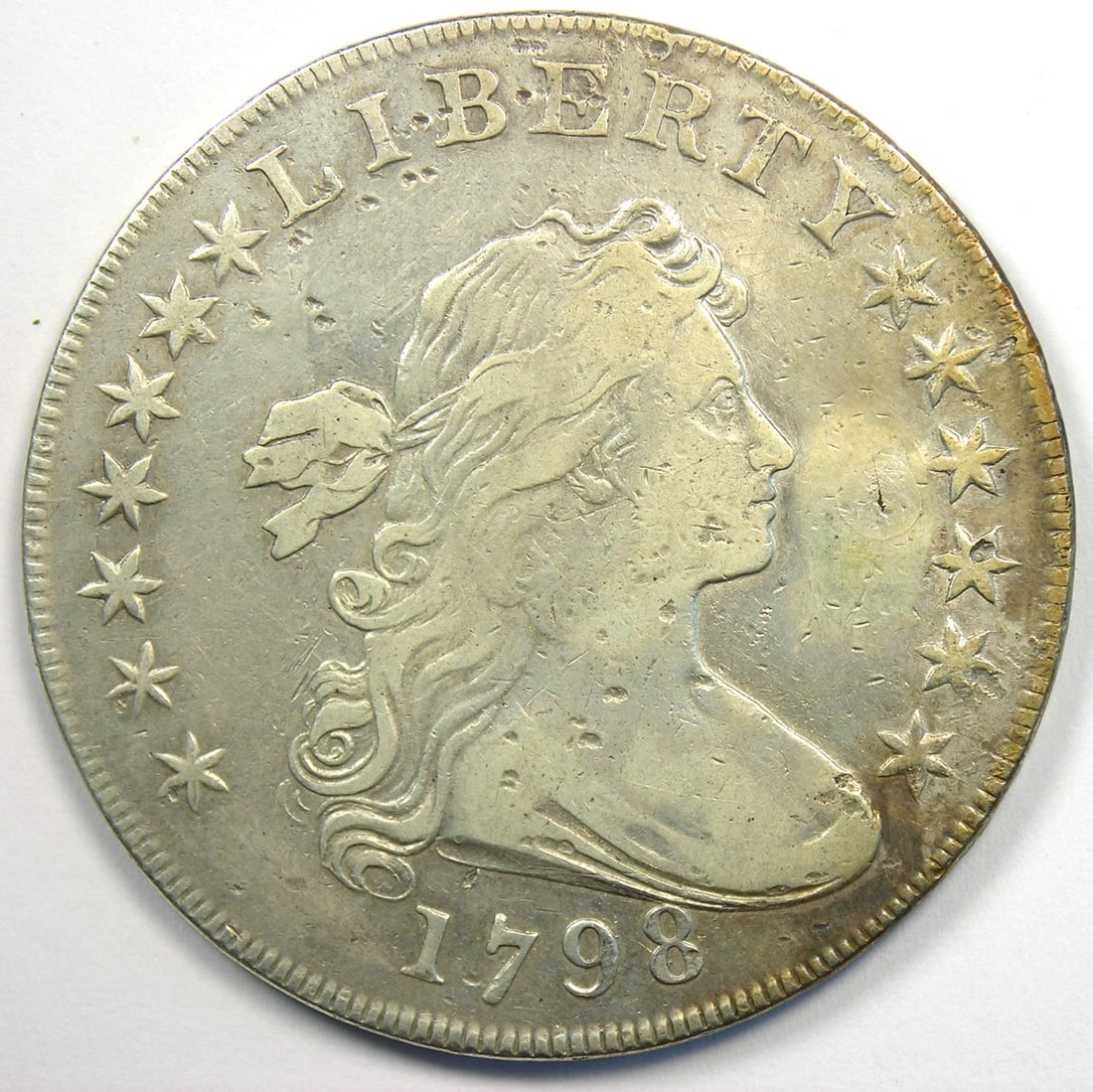 1798 DRAPED BUST SILVER DOLLAR $1 COIN: 1798 Draped Bust Silver Dollar $1 Coin Year: 1798 Denomination: $1 Country of Origin: United States Accessories: None Accessories Notice: When purchasing pre-owned goods, please refer to the photos
