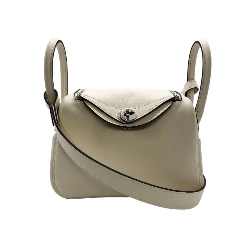 HERMES LINDIMINI VERSO SHOULDER BAG: HERMES Lindimini Verso Shoulder Bag Brand: HERMES Type/Style: Shoulder Bag Material: Swift Color: Nata, Sesame, SilverHardware Size: W7.5 x H4.9x D0.0inch Accessories: None Accessories Notice: When