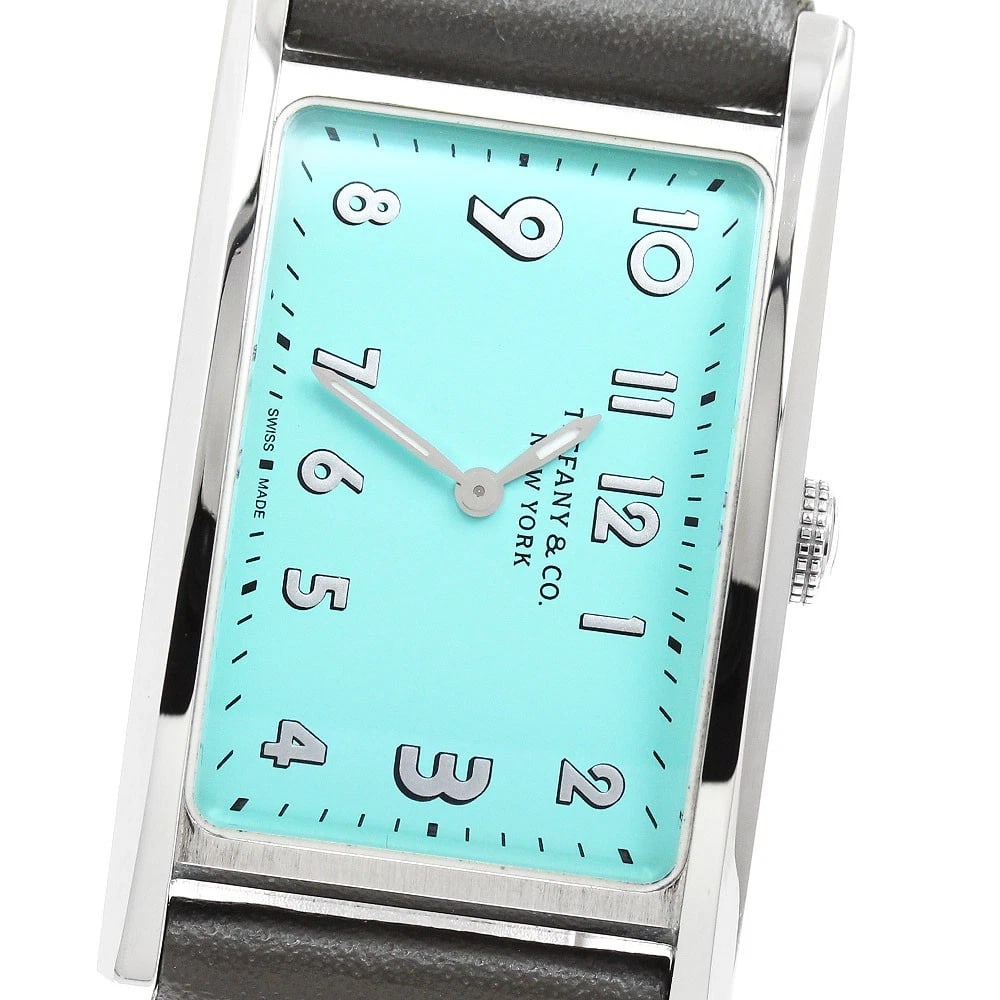 TIFFANY&CO. EAST WEST MINI BLUE DIAL QUARTZ WATCH: TIFFANY&Co. East West Mini blue Dial Quartz Watch Brand: TIFFANY&Co. Type/Style: Wristwatch Material: Band Material leather, Case Material Stainless Steel Color: Band Color gray, Case Color Silver,