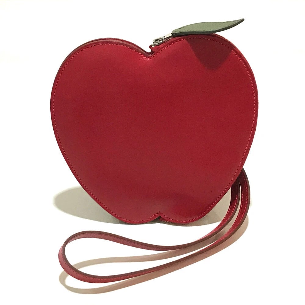 HERMES TADELAKT X CHEVRE APPLE MOTIF POCHETTE-POM POUCH: HERMES Tadelakt x Chevre Apple motif Pochette-Pom Pouch Brand: HERMES Type/Style: Accessory pouch Material: Chevre Color: Rouge Viff Size: W6.7xH6.3inch / W17cmxH16cm Accessories: None Acc