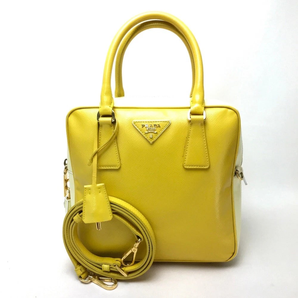 PRADA BICOLOR SAFFIANO VERNIS SHOULDER BAG HAND BAG: PRADA Bicolor Saffiano Vernis Shoulder Bag Hand Bag Brand: PRADA Type/Style: Hand Bag Material: Leather Color: yellowxWhite Size: W8.9xH8.7xD3.3inch / W22.5cmxH22cmxD8.5cm Accessories: None