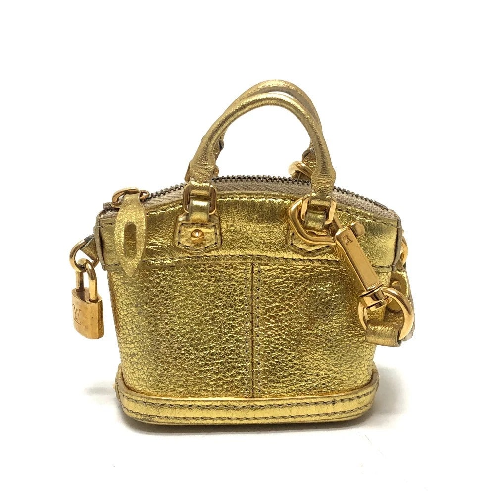 LOUIS VUITTON MINI LOCKIT SMALL ITEM KEY HOLDER MINI POUCH BAG: LOUIS VUITTON Mini Lockit Small item Key Holder Mini Pouch Bag Brand: LOUIS VUITTON Type/Style: Bag Charm Material: Suhari leather Color: Gold Size: W3.5xH2.8xD1.8inch / W9cmxH7cmxD4.5cm Accessori
