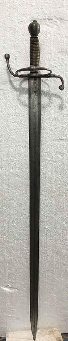 Decorated German Broad Blade Sword Circa 1650: Inscribed on the blade 'E Domine Spera Vinon' and on the other side 'Funar Ineternum' hilt including recurved quillons with terminating globular tips outer ring-guard on the guard globular pommel orig