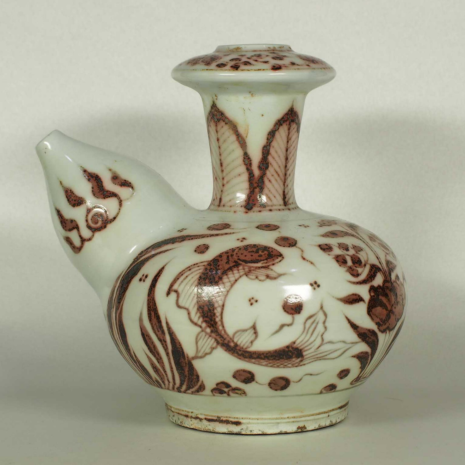 Mammiform Spout Kendi with Fish Design, early Ming: Very rare and beautiful underglaze copper red mammiform spout kendi with fish and waterweeds design. Height 177mm, 7"inch