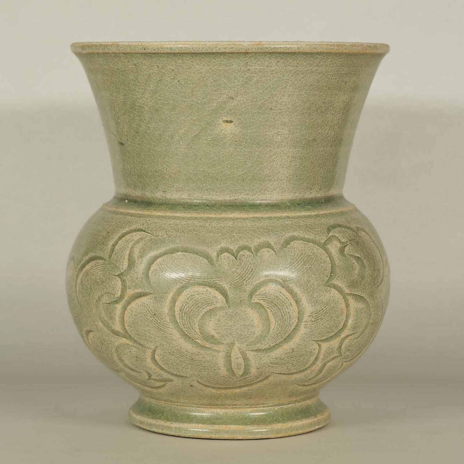 Yue Spittoon with Carved Peony, Song: Beautiful and rare Yue spittoon with carved and combed peony. Obvious calcification on its glaze. A rare find. Height 155mm, 6"inch