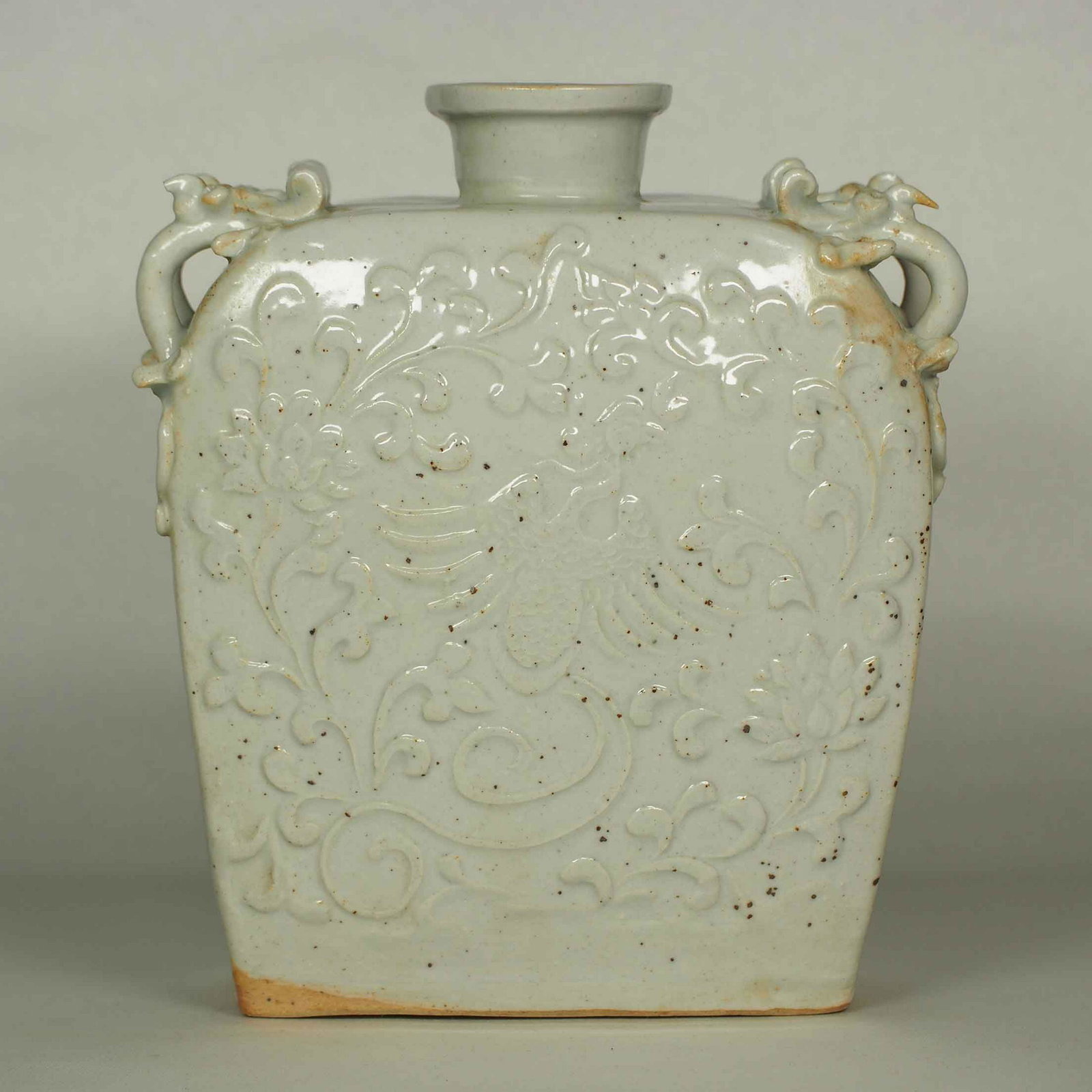 Dragon-Form Handled Flask with Phoenix, Yuan early Ming: Very rare and beautiful luanbai white glaze impressed-moulded phoenix and dragon-form handled flask. Height 160mm, 6-1/3"inch