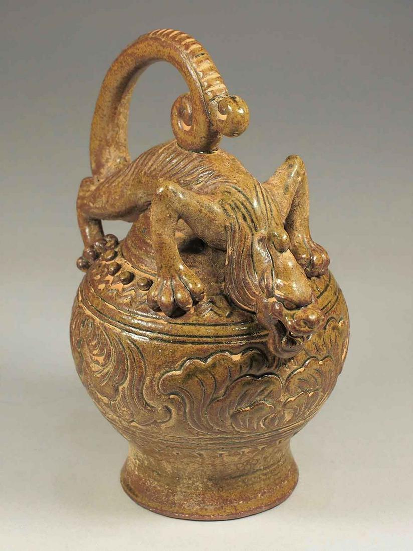 Reverse-Flow Ewer with Qilin Shape Handle, 6 Dynasties: Unique brownish celadon 'Daozhuanghu' reverse-flow ewer with Qilin shape handle and carved peony on its shoulder. A rare find! Height 215mm, 8-1/2"inch