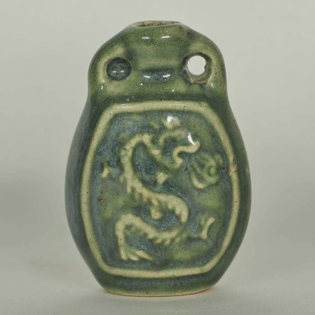 Longquan Perfume Bottle, Late Ming: Unique and rare emerald green Longquan perfume bottle with carved dragon motif. Height 56mm, 2-1/5"inch