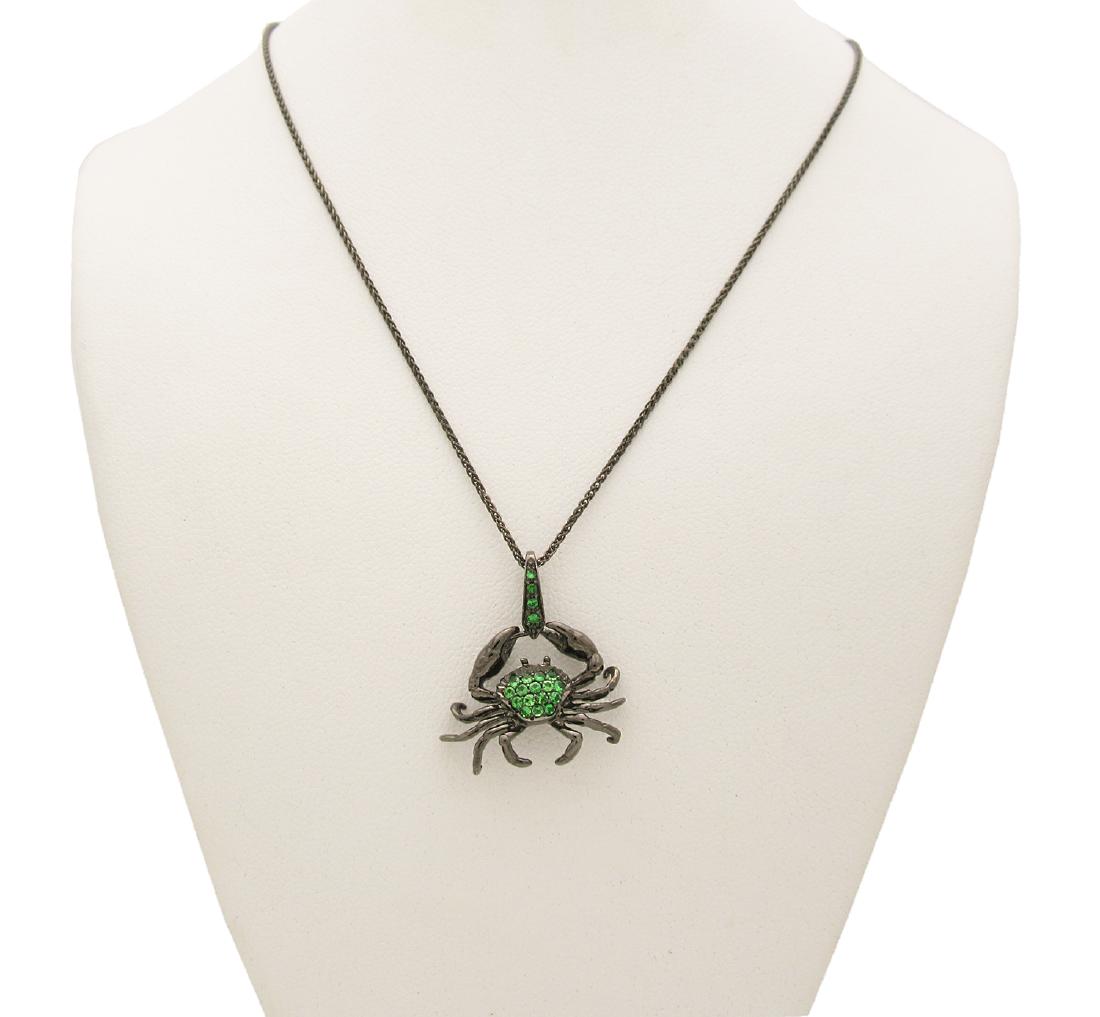 Stephen Webster 18k Darken Gold Astro Cancer Pendant: Stephen Webster 18k Darken Gold Astro Cancer Pendant Brand: Stephen Webster Metal:18k Darken Gold Gemstones: Peridot Length: 16" Measurements of the pendant: 16mm. x 21mm. Condition: Excellent