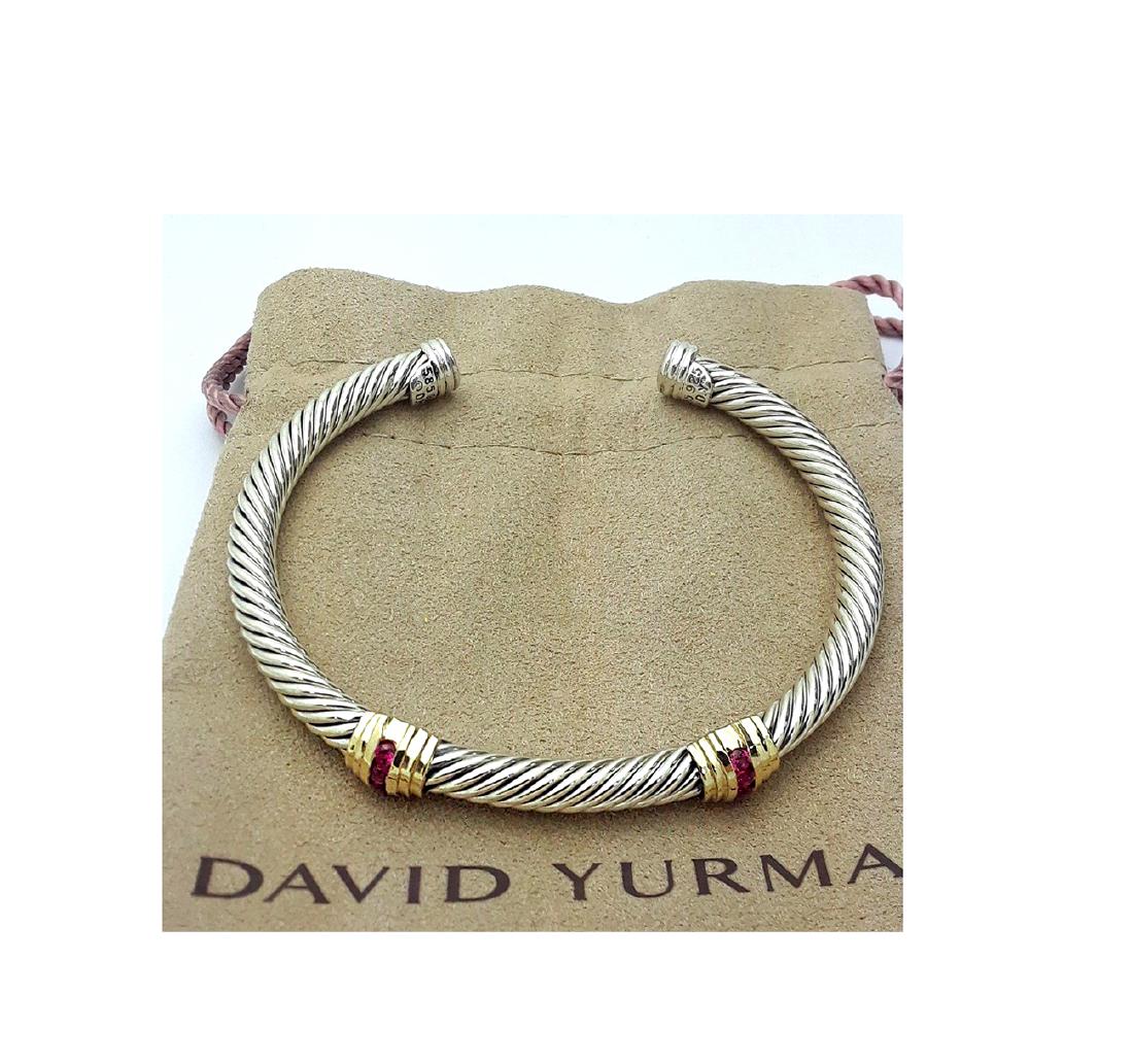 David Yurman Sterling Silver &14K Gold Double Stations: David Yurman Sterling Silver &14K Gold Double Stations Ruby 5mm Bracelet Metal: Sterling Silver and 14K Yellow Gold Stone: Ruby Cable width: 5mm. Size:: Small (6,25”) Condition: Like New Comes in D.