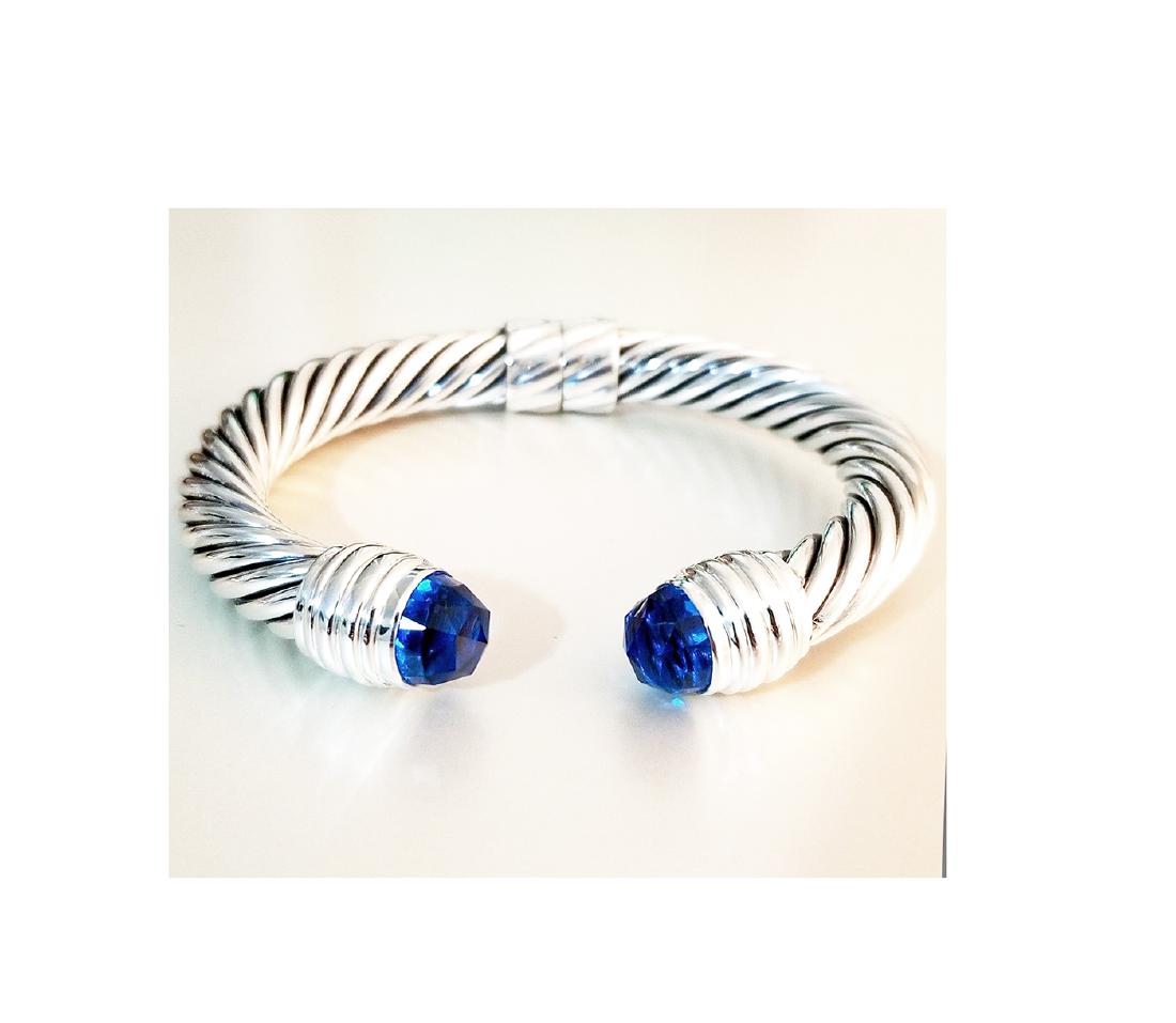 David Yurman 925 Sterling Silver Crossover Diamond Ring: David Yurman 925 Sterling Silver Crossover Diamond Ring Sz 7.5 Retail price: $850 Brand: David Yurman Material: 925 Sterling Silver Diamond: 0.18TCW Width: 11mm. Size: 7.5 Condition: Like New Comes wi