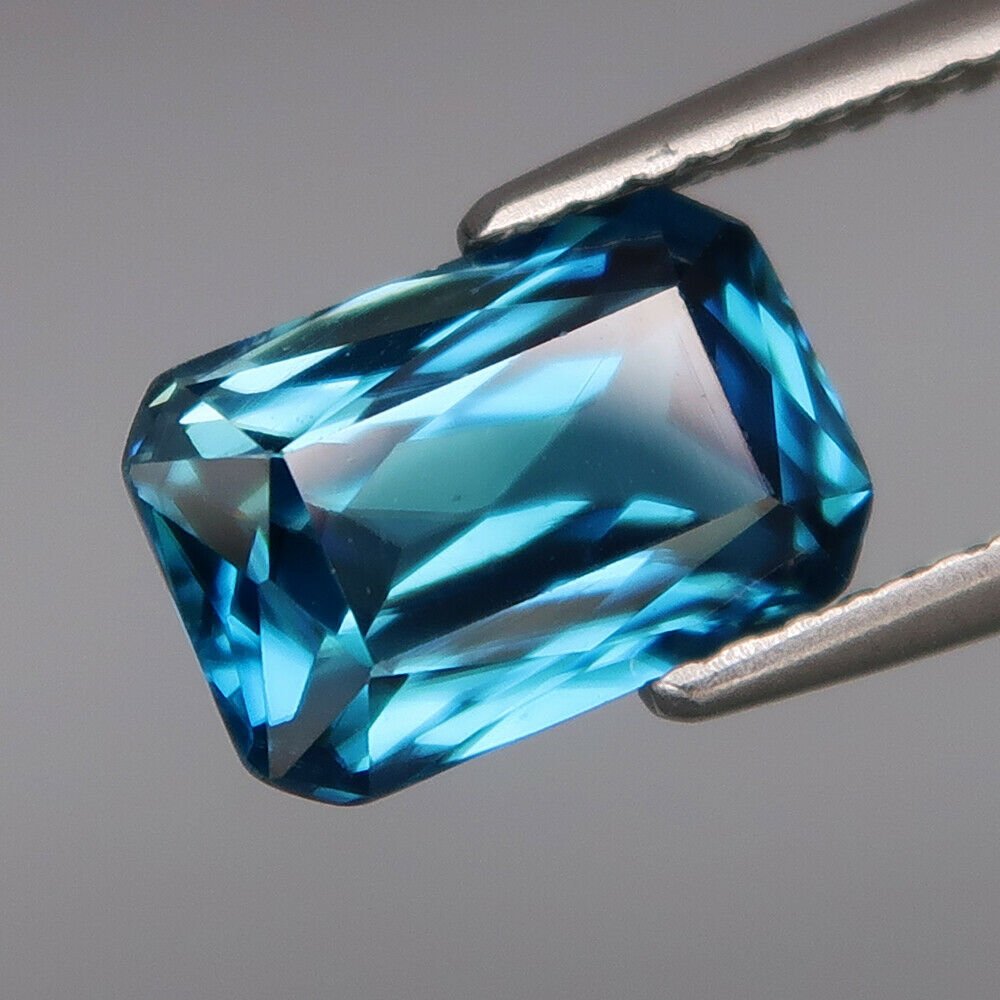 RARE IGI Cert. 3.46 ct. Natural Blue Zircon - CAMBODIA: RARE IGI Certified 3.46 ct. Natural Blue Zircon - CAMBODIA Color - Blue Clarity - VS Cut - Radiant Cut Ct. Weight - 3.46 ct. Dimensions - 9.62 x 6.37 x 4.49 mm 