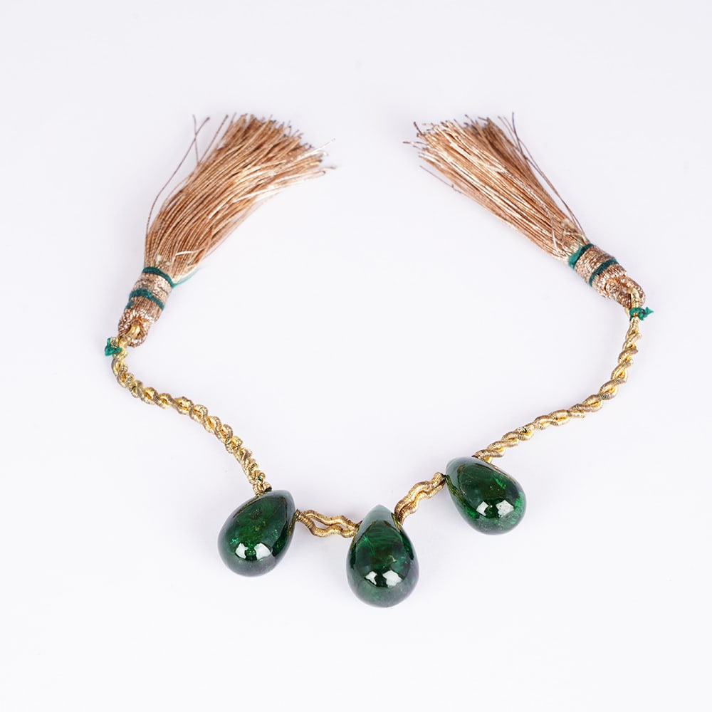 GIA Cert. 25.08 ct. (3) Tsavorite Garnet Beads KENYA: GIA Certified 25.08 ct. Three (3) Tsavorite Beads (Grossular-Garnet) - KENYA, EAST-AFRICA Three (3) green beads strung on a yellow cord with 2 yellow tassels Cut - Drop Shape Beads Color - Green</