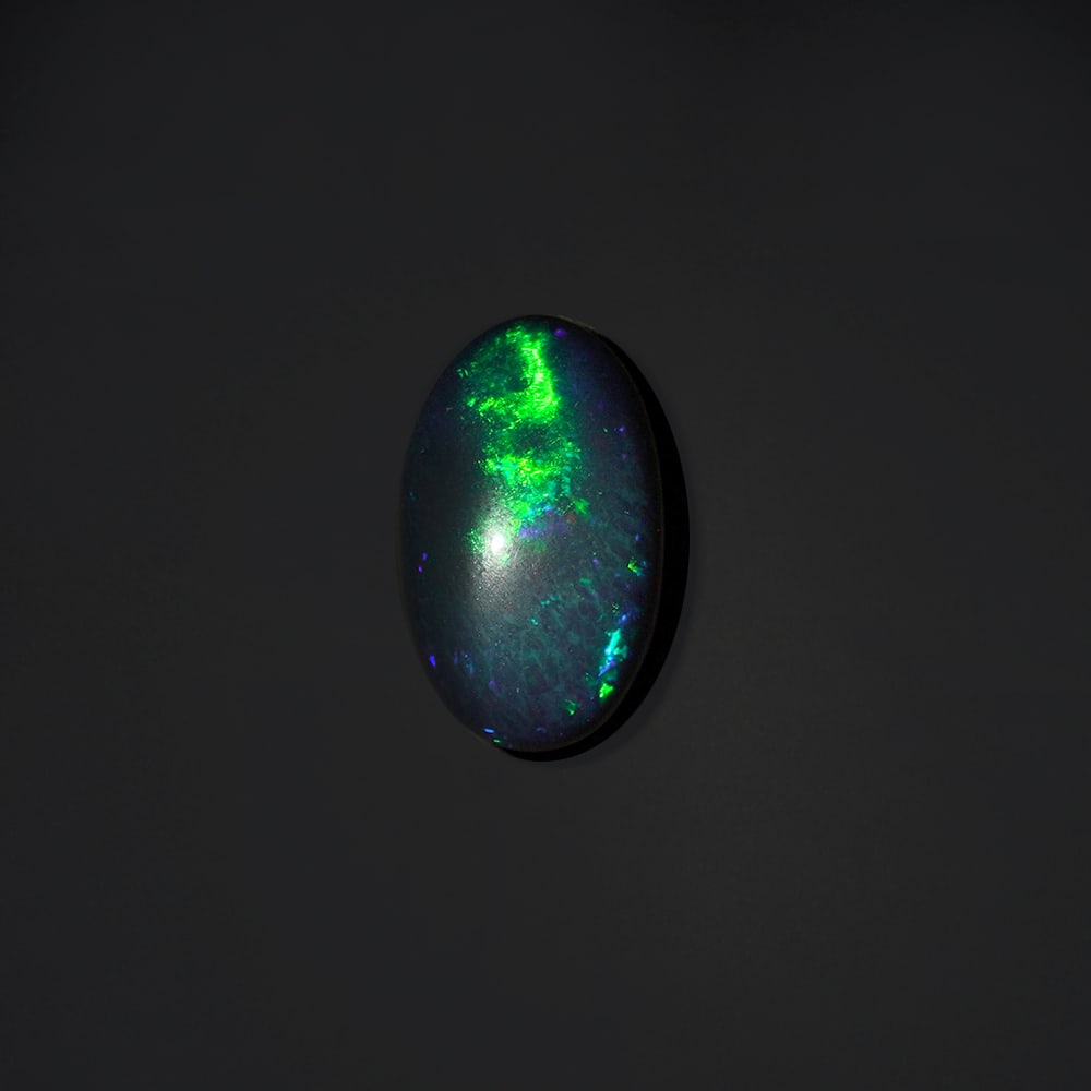 11.50 ct. Natural Play of Color Opal - ETHIOPIA: 11.50 ct. Natural Play of Color Opal - ETHIOPIA Shape - Oval Cabochon Color -Play of color Clarity - Opaque Ct. Weight - 11.50 ct. Origin - ETHIOPIA