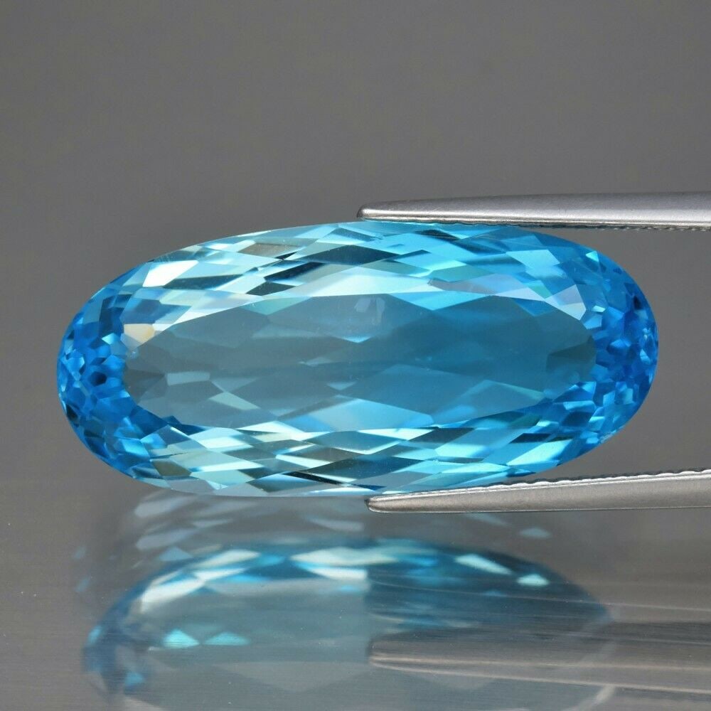 17.63 ct. Natural Blue Topaz - BRAZIL: 17.63 ct. Natural Blue Topaz - BRAZIL Color - Blue Clarity - VVS Cut - Oval Ct. Weight - 17.63 ct. Dimensions - 23.00 x 10.50 x 7.70 mm Origin - BRAZIL </