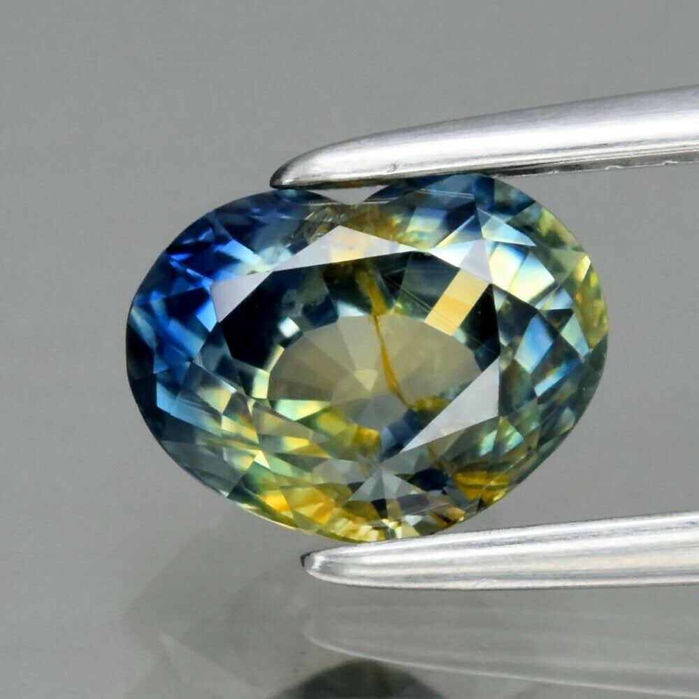 RARE 1.29 ct. Natural Tri-color Sapphire - AUSTRALIA: RARE 1.29 ct. Natural Tri-color Sapphire - AUSTRALIA Shape - Heart Color - Tri-color (Blue, Green, Yellow) Clarity - VS Ct. Weight - 1.29 ct. Dimensions - 7.00 x 5.30 x 4.10 mm O