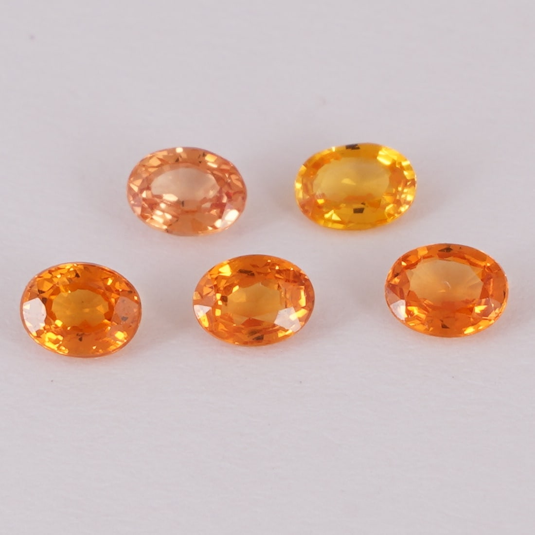 IGI Cert. 1.14 ct. Set of 5 Sapphires - SRI LANKA: IGI Certified 1.14 ct. Set of 5 Sapphires - SRI LANKA, CEYLON Color - Orange & Yellowish Orange Cut - Oval Mixed cut Clarity - VS Ct. Weight - 0.27 + 0.24 + 0.23+ 0.22 + 0.18 = 1.14 ct. Dime