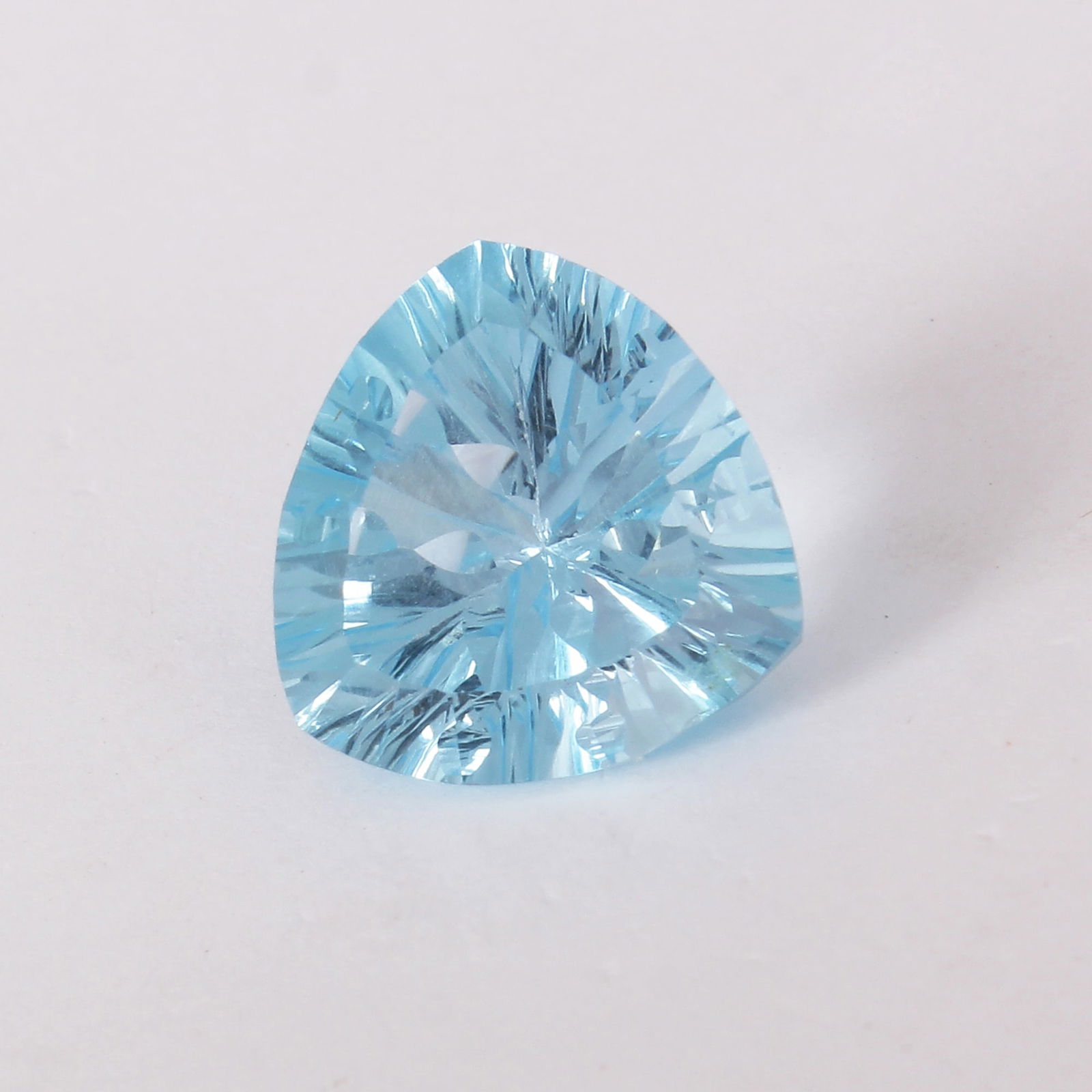 GFCO (SWISS) Certified 10.46 ct. Blue Topaz - BRAZIL: GFCO (SWISS) Certified 10.46 ct. Blue Topaz - BRAZIL Cut - Trillion Fancy Cut Color - Blue Ct. Weight - 10.46 ct. Clarity - VVS Dimensions - 14.00 X 13.9 X 8.78 mm </