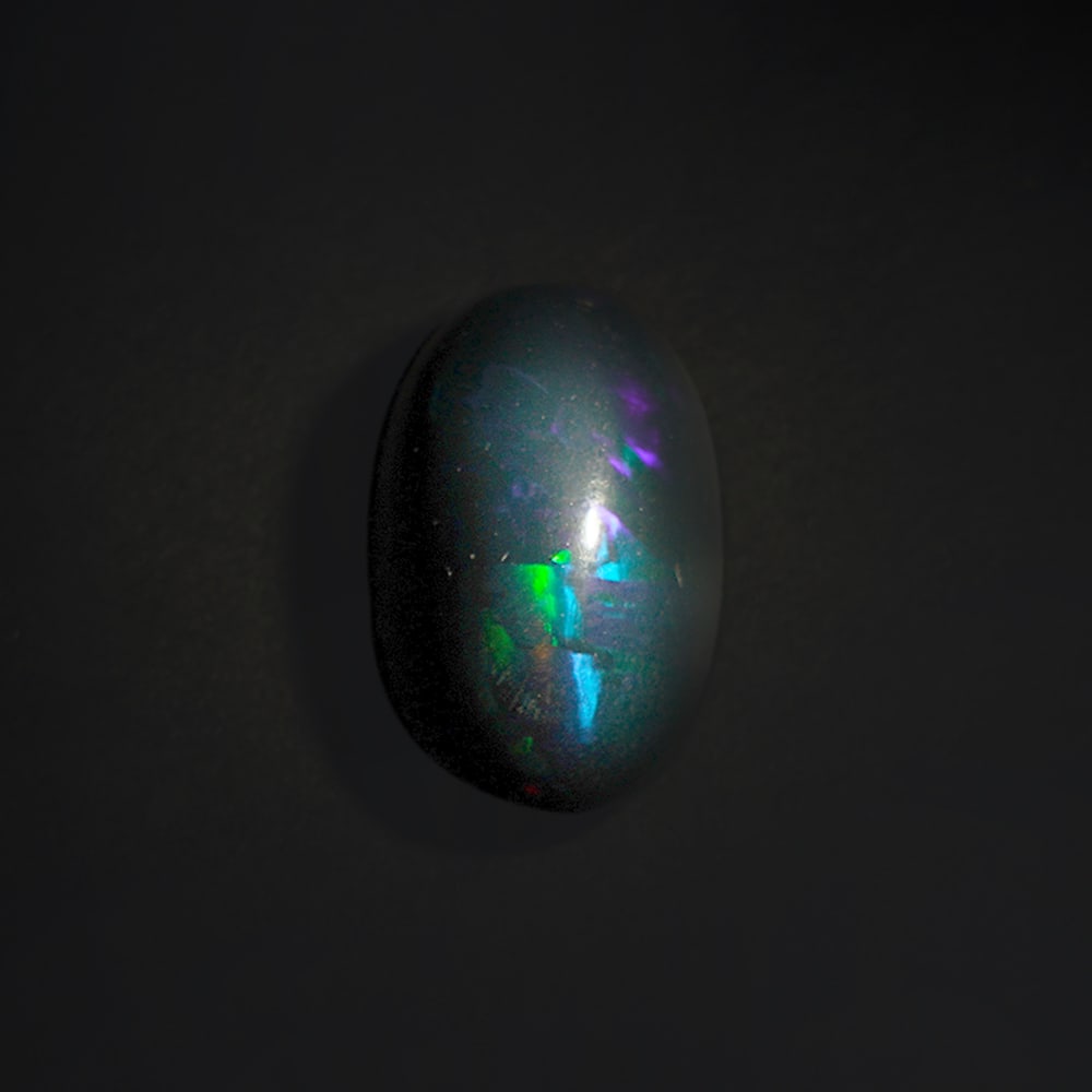 8.95 ct. Natural Play of Color Opal - ETHIOPIA: 8.95 ct. Natural Play of Color Opal - ETHIOPIA Shape - Oval Cabochon Color -Play of color Clarity - Opaque Ct. Weight - 8.95 ct. Origin - ETHIOPIA