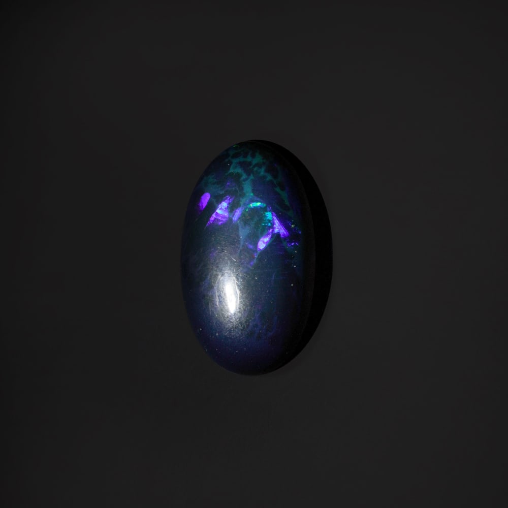 8.40 ct. Natural Play of Color Opal - ETHIOPIA: 8.40 ct. Natural Play of Color Opal - ETHIOPIA Shape - Oval Cabochon Color - Play of color Clarity - Opaque Ct. Weight - 8.40 ct. Origin - ETHIOPIA