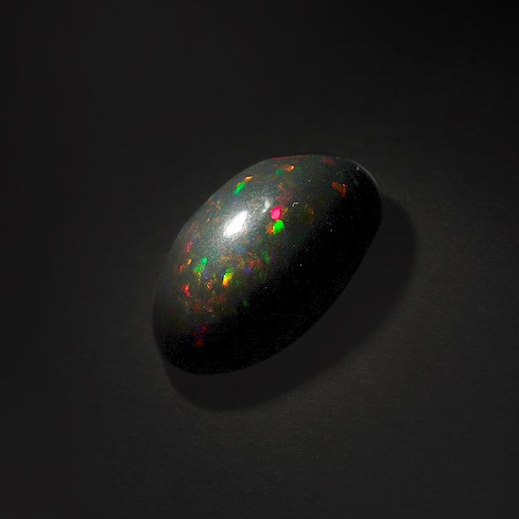 13.05 ct. Natural Play of Color Opal - ETHIOPIA: 13.05 ct. Natural Play of Color Opal - ETHIOPIA Shape - Oval Cabochon Color - Play of color Clarity - Opaque Ct. Weight - 13.05 ct. Origin - ETHIOPIA