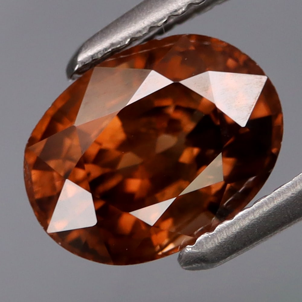 HGL Certified 2.02 ct. Zircon - TANZANIA: HGL Certified 2.02 ct. Zircon - TANZANIA Ct. Weight - 2.02ct. Shape - Oval Color - Orange Dimensions - 7.30 x 5.50 x 4.80 mm Clarity - SI Treatment - Unheated ORIGI
