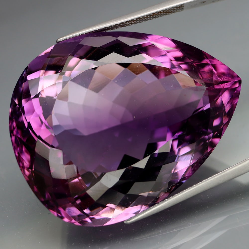 HGL Certified 101.90 ct. Amethyst - BOLIVIA: HGL Certified 101.90 ct. Amethyst - BOLIVIA Color - Purple Cut - Pear Ct. Weight - 101.90 ct. Size - 35.8 X 28.6 X 18mm Treatment - None ORIGIN - BOLIVIA