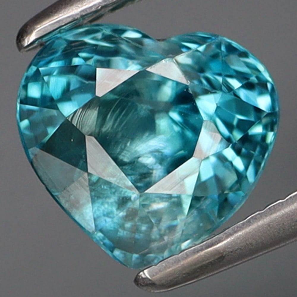 HGL Certified 1.67 ct. Zircon - CAMBODIA: HGL Certified 1.67 ct. Zircon - CAMBODIA Color - Blue Cut - Heart Ct. Weight - 1.67 ct. Size - 6.7 X 6.2 X 4.5mm Treatment - Heated Clarity - SI ORIGIN - CAMBODIA</