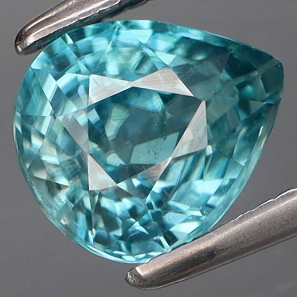 HGL Certified 1.86 ct. Zircon - CAMBODIA: HGL Certified 1.86 ct. Zircon - CAMBODIA Color - Blue Cut - Pear Ct. Weight - 1.86 ct. Size - 7.3 X 6.3 X 4 mm Treatment - Heated Clarity - SI ORIGIN - CAMBODIA