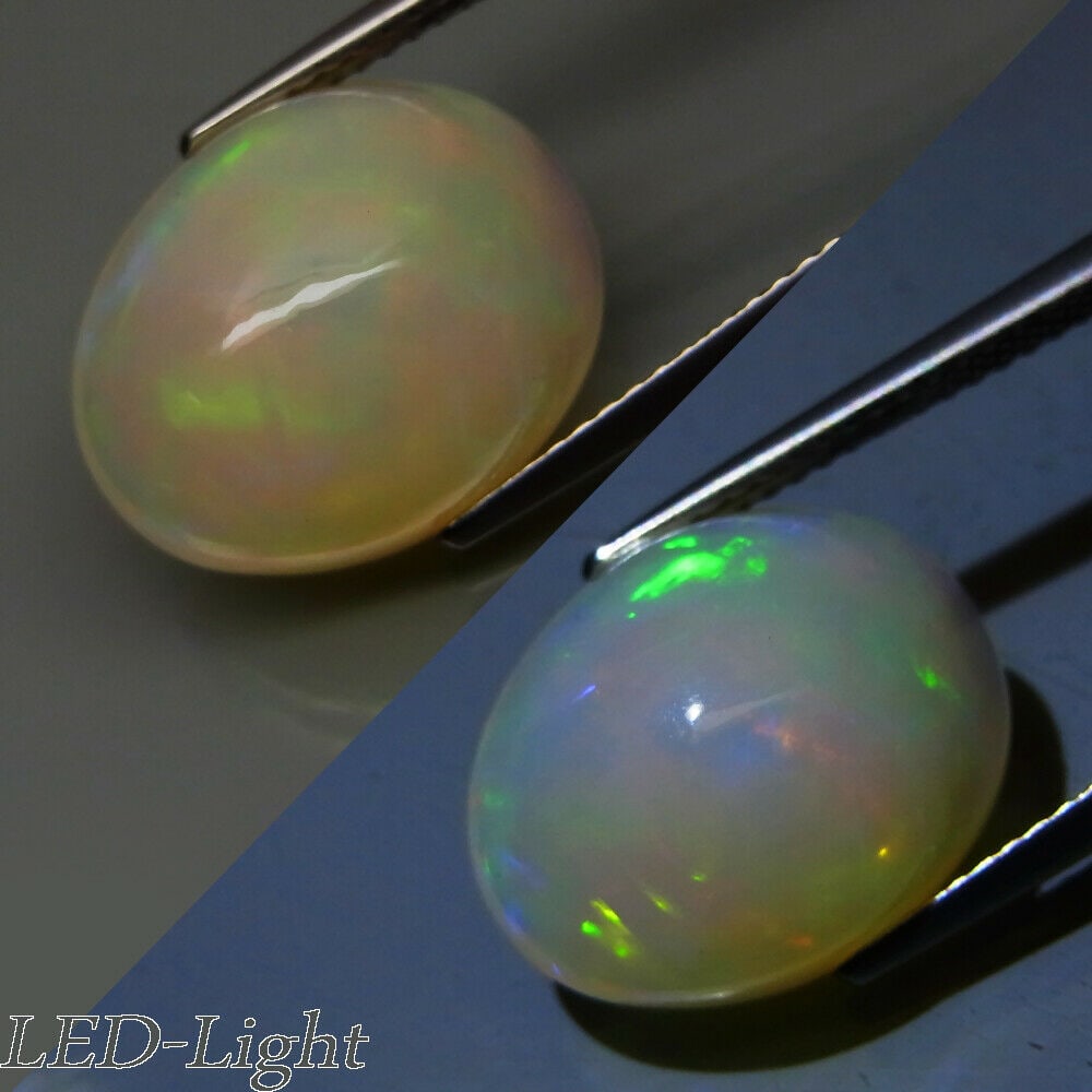 7.31 ct. Natural Play of Color White Opal - ETHIOPIA: 7.31 ct. Natural Play of Color White Opal - ETHIOPIA Shape - Oval Cabochon Color - Rainbow Flash Clarity - Semi Transparent Ct. Weight - 7.31 ct. Dimensions - 15.20 x 12.00 x 8.70 mm </