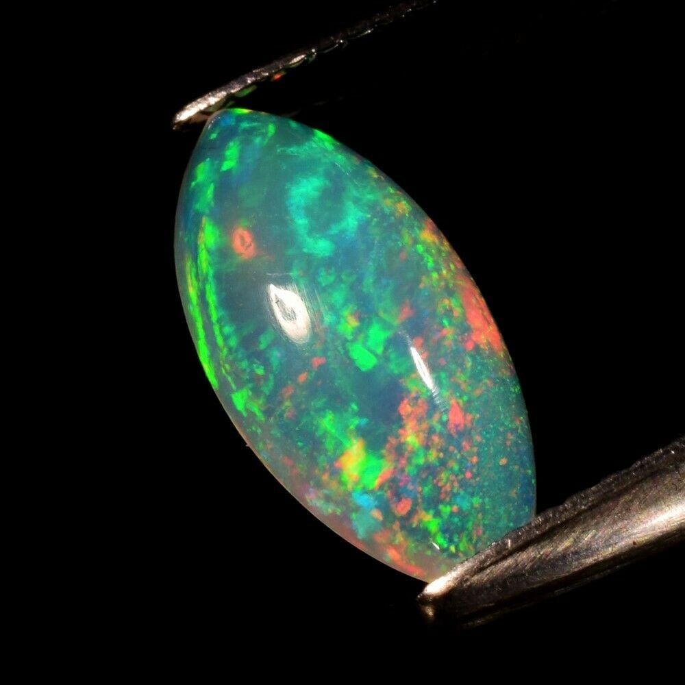 1.76 ct. Natural Play of Color White Opal - ETHIOPIA: 1.76 ct. Natural Play of Color White Opal - ETHIOPIA Shape - Marquise Cabochon Color - Floral Flash Rainbow (White-Red-Orange-Green-Yellow-Violet-Blue Flashing) Clarity - Semi-Transparent Ct. Weight