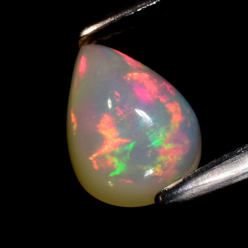 1.79 ct. Play of Color Crystal Opal - ETHIOPIA: 1.79 ct. Play of Color Crystal Opal - ETHIOPIA Cut - Pear Cabochon Color - Floral Flash Rainbow (White, Red, Orange, Green, Yellow, Violet, Blue Flashing) Ct. Weight - 1.79 ct. Clarity - Semi-Trans