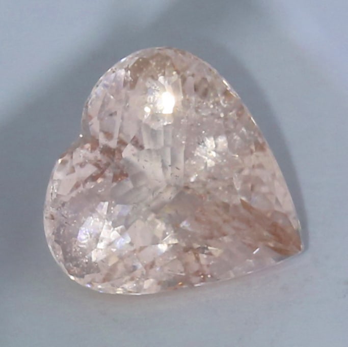 IGI Certified 10.55 ct. Beryl Untreated BRAZIL: IGI Certified 10.55 ct. Beryl Untreated BRAZIL Color - Pinkish Orange Cut - Heart Mixed cut Ct. Wt. - 10.55 ct. Clarity - VS Dimensions - 14.86 x 14.53 x 9.45 mm Origin - Not on
