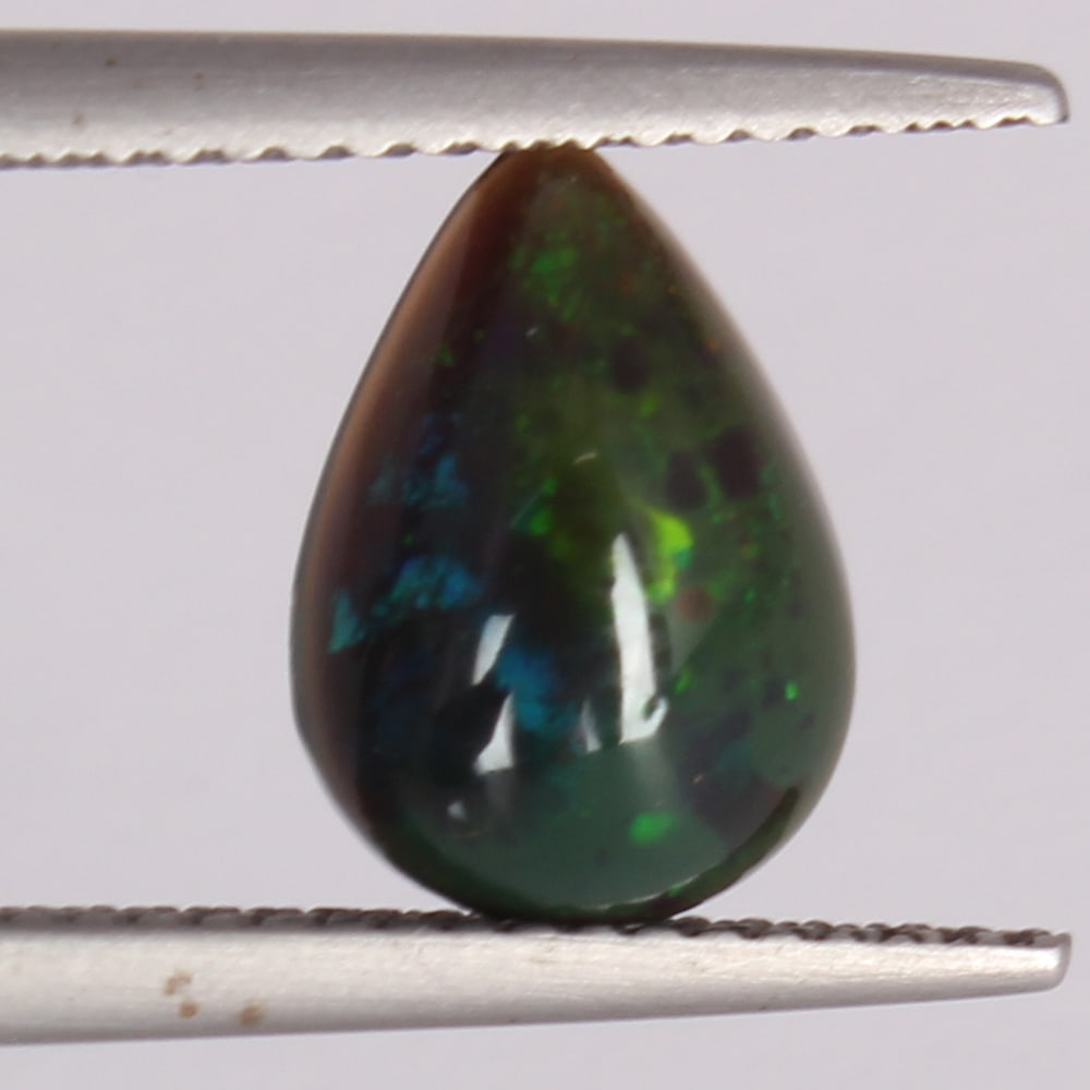 GFCO Certified 1.46 ct. Bluish-Green OPAL - AUSTRALIA: GFCO (Swiss) Certified 1.46 ct. Bluish-Green OPAL - AUSTRALIA Cut - Pear Cabochon Color - Bluish Green with play of color Ct. Weight - 1.46 ct. Dimensions - 10.92 x 7.72 x 4.05 mm Orig
