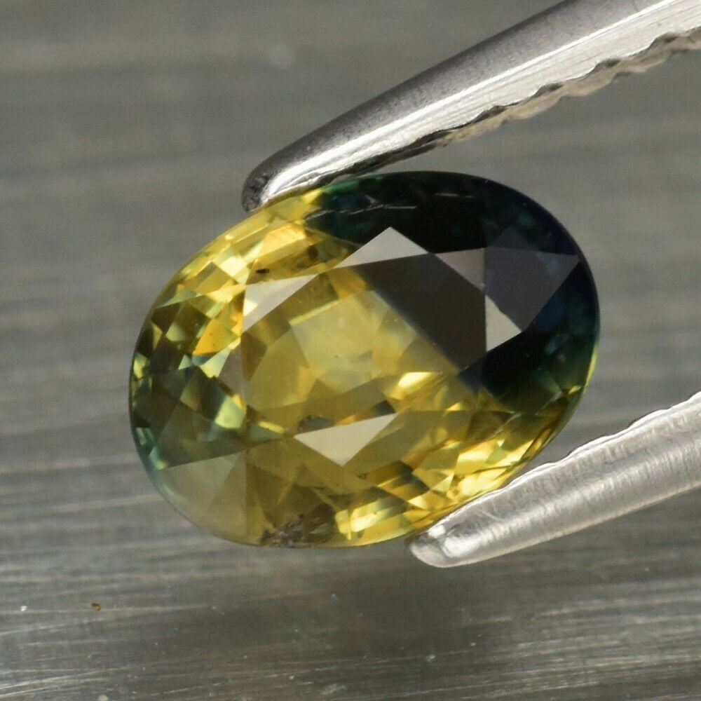 1.07 ct. Natural Blue & Yellow Sapphire - AUSTRALIA: 1.07 ct. Natural Blue & Yellow Sapphire - AUSTRALIA Color - Blue & Yellow Cut - Oval Ct. Wt. - 1.07 ct. Clarity - SI1 Dimensions - 6.50 x 4.80 x 3.80 mm Origin - AUSTRALI