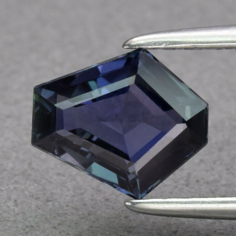 IGI Certified 1.19 ct. Natural Color change Sapphire - TANZANIA: IGI Certified 1.19 ct. Natural Color change Sapphire - TANZANIA Color - Greenish Blue to Purple Cut - Shield step cut Ct. Wt. - 1.19 ct. Clarity - IF Dimensions - 7.58 x 6.59 x 3.16 mm